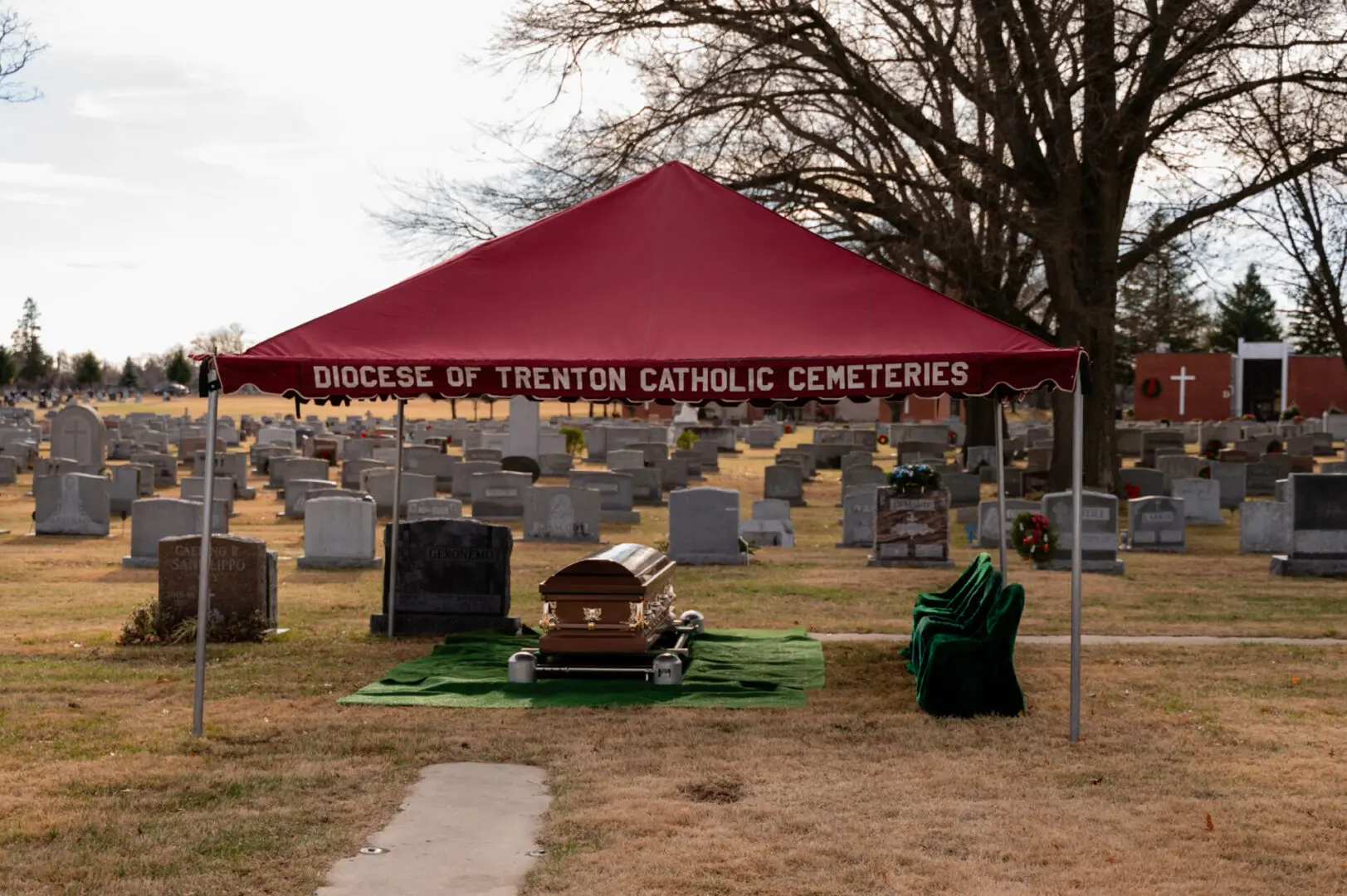 Coffin beneath tent in a cemetery.